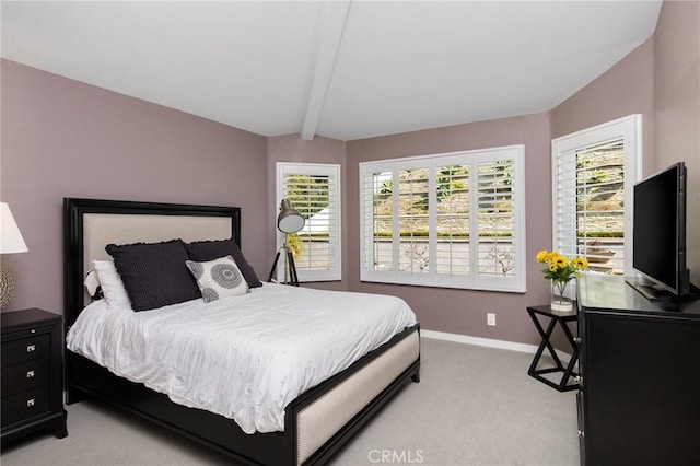 carpeted bedroom featuring vaulted ceiling with beams