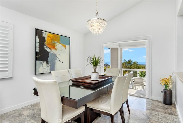 dining room with a chandelier and vaulted ceiling