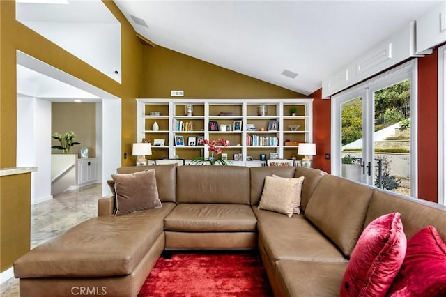 living room featuring lofted ceiling and french doors