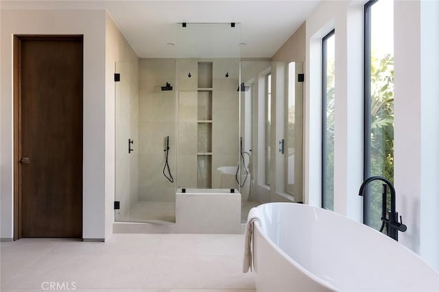 bathroom with independent shower and bath and tile patterned floors