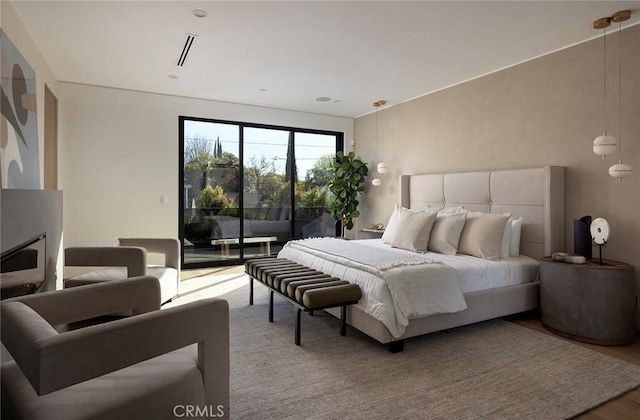 bedroom featuring hardwood / wood-style flooring and access to outside