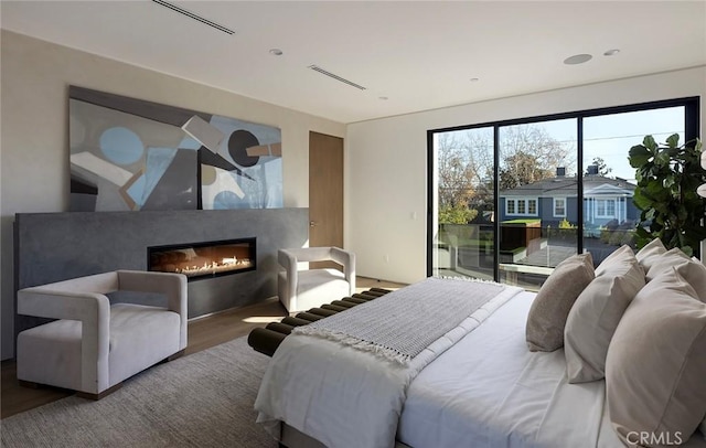 bedroom featuring access to outside and wood-type flooring