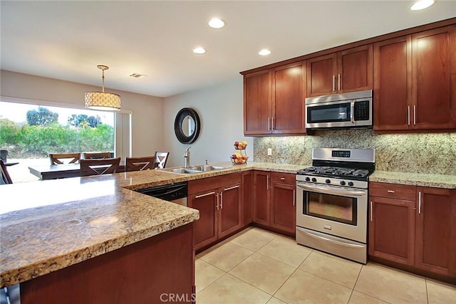 kitchen featuring sink, light tile patterned floors, appliances with stainless steel finishes, hanging light fixtures, and backsplash