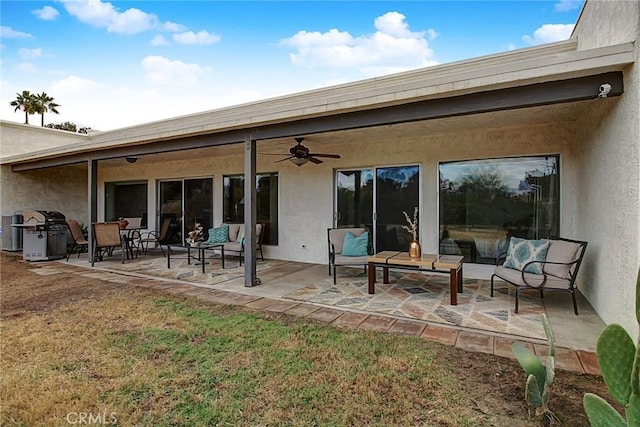 back of property with an outdoor living space, a lawn, a patio, and ceiling fan