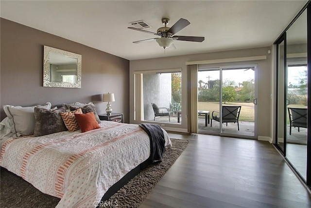 bedroom with dark hardwood / wood-style floors, ceiling fan, and access to exterior