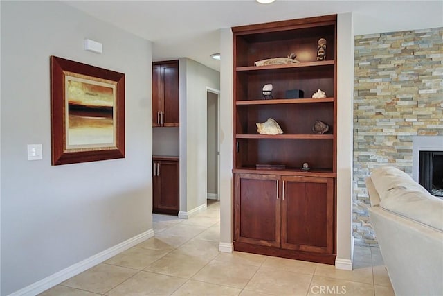 hallway featuring light tile patterned floors and built in features