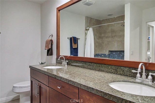 bathroom featuring vanity, toilet, and a shower with shower curtain