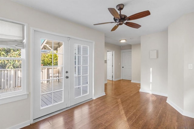 doorway featuring hardwood / wood-style floors, french doors, and ceiling fan