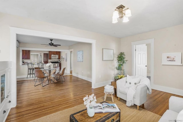 living room with a chandelier and light hardwood / wood-style floors