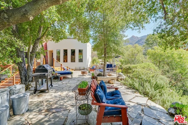 view of patio / terrace featuring a mountain view and area for grilling