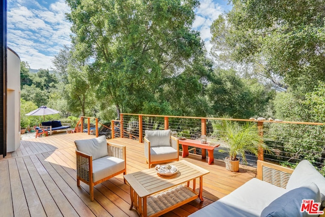 wooden terrace with an outdoor hangout area