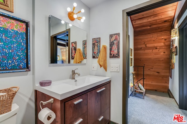 bathroom featuring vanity, a notable chandelier, wood ceiling, and toilet