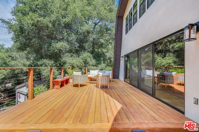 wooden terrace featuring an outdoor hangout area