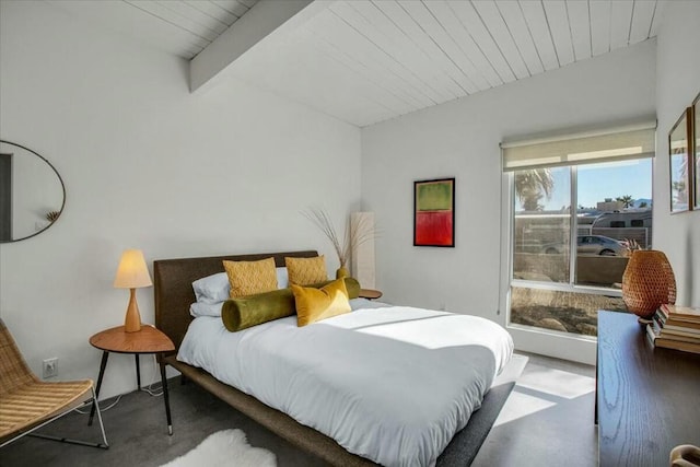 carpeted bedroom with lofted ceiling with beams and wooden ceiling