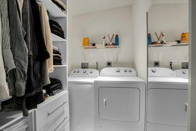 clothes washing area with separate washer and dryer