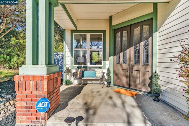 view of exterior entry with covered porch