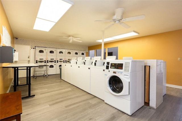 laundry area featuring ceiling fan, stacked washer and dryer, light hardwood / wood-style floors, and washing machine and dryer