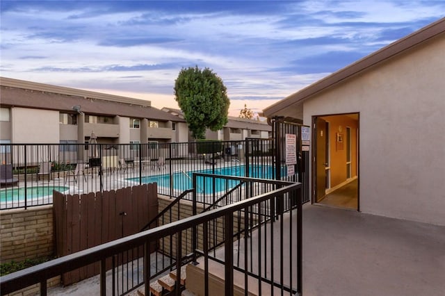 pool at dusk with a patio