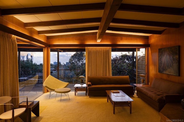 interior space featuring beamed ceiling, carpet, and wood walls