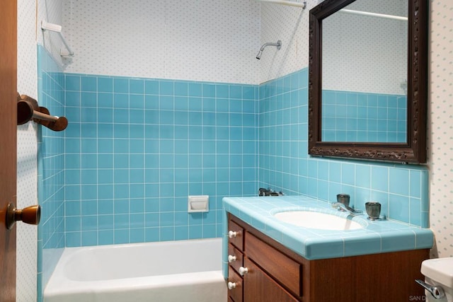 full bathroom featuring vanity, tub / shower combination, tile walls, and toilet