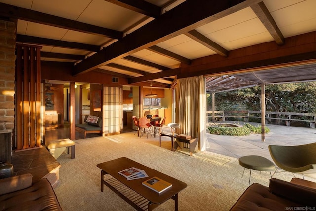 living room featuring vaulted ceiling with beams and carpet