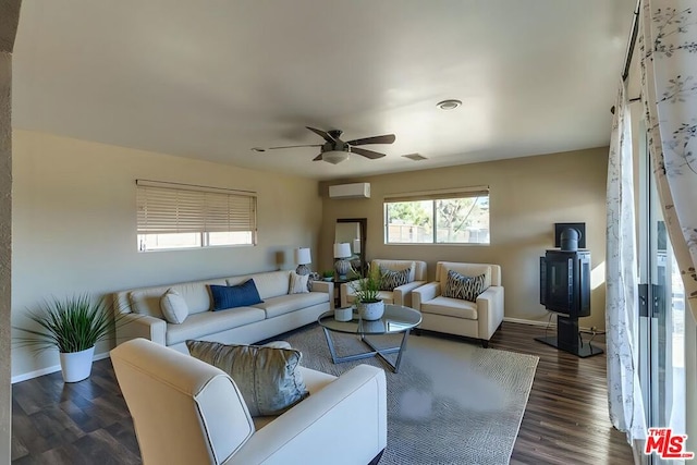 living room with ceiling fan, dark hardwood / wood-style floors, and a wall unit AC