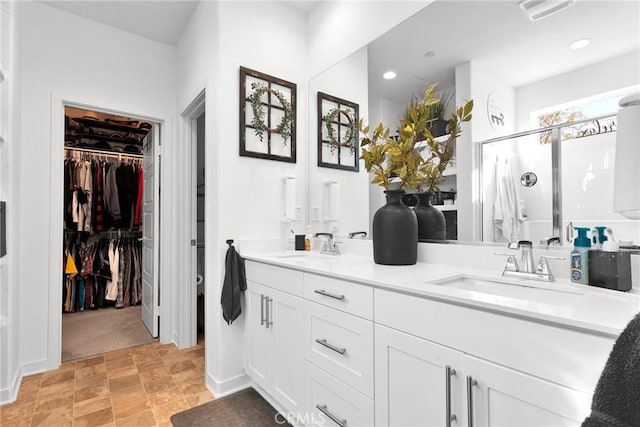 bathroom featuring an enclosed shower and vanity