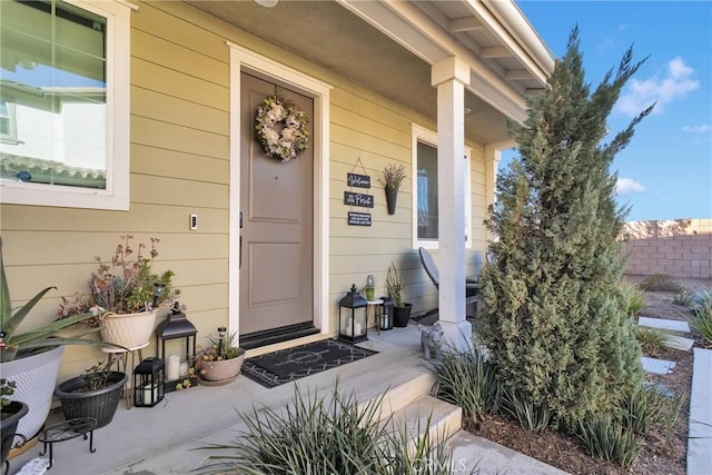 view of exterior entry with covered porch