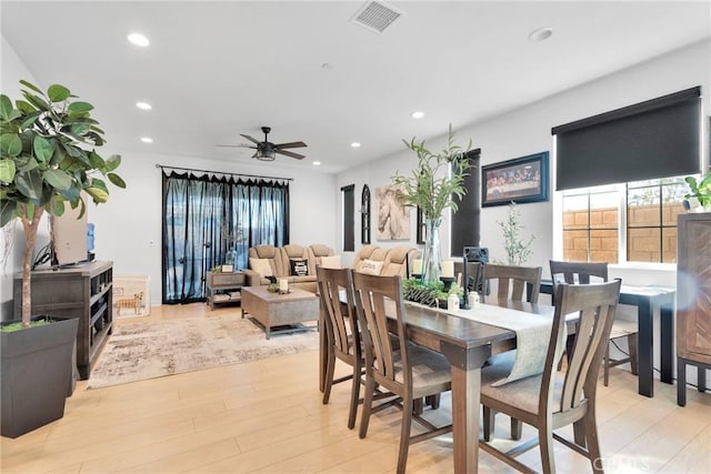 dining space featuring ceiling fan and light hardwood / wood-style flooring