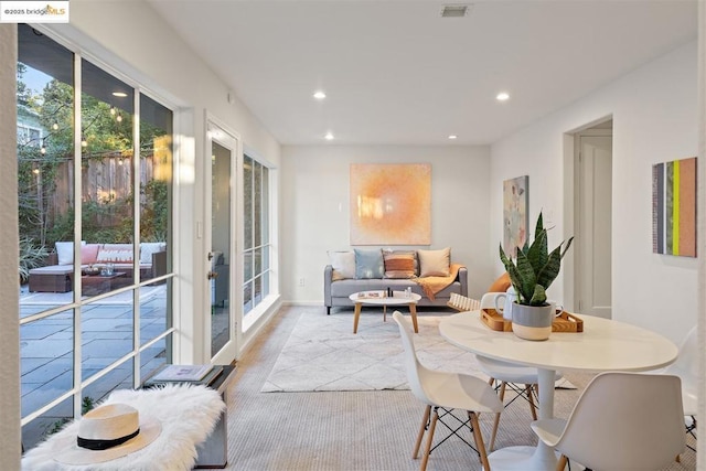 carpeted dining room featuring french doors