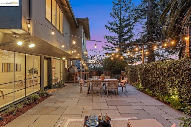 view of patio terrace at dusk