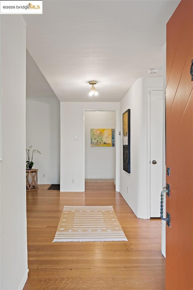 hall with light hardwood / wood-style floors