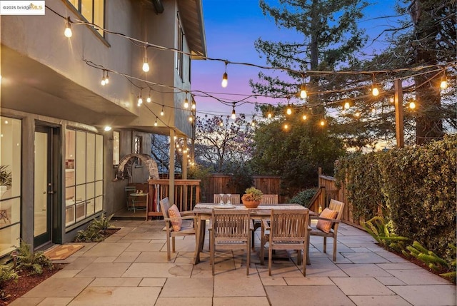 view of patio terrace at dusk