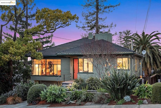 view of back house at dusk