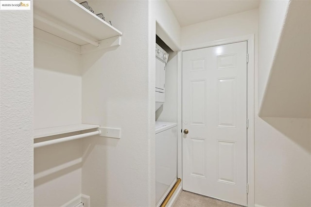 walk in closet featuring stacked washer and clothes dryer