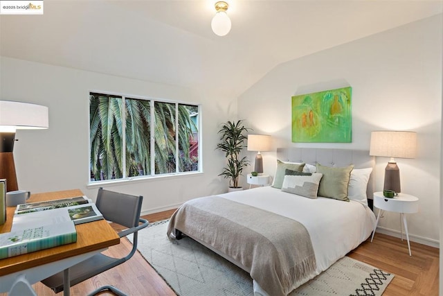 bedroom featuring lofted ceiling and light hardwood / wood-style flooring