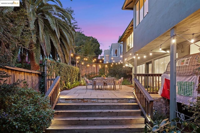 deck at dusk with a patio area