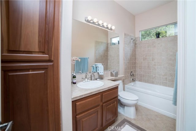 full bathroom with tiled shower / bath, vanity, tile patterned floors, and toilet