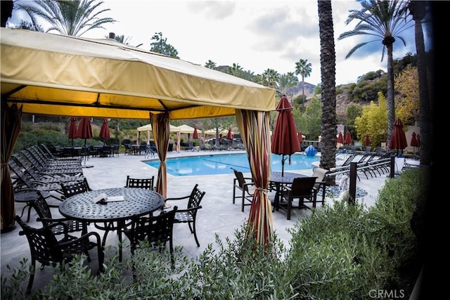 view of swimming pool featuring a gazebo and a patio area