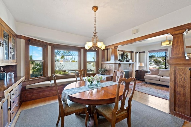 dining area with an inviting chandelier and light hardwood / wood-style flooring