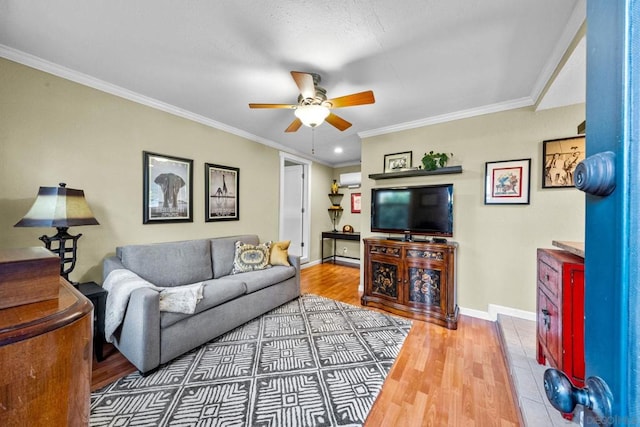 living room featuring hardwood / wood-style flooring, crown molding, and ceiling fan