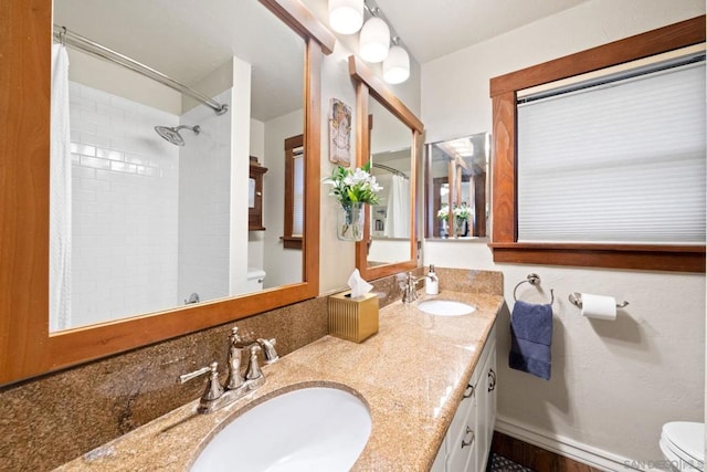 bathroom featuring vanity, toilet, and a shower with shower curtain