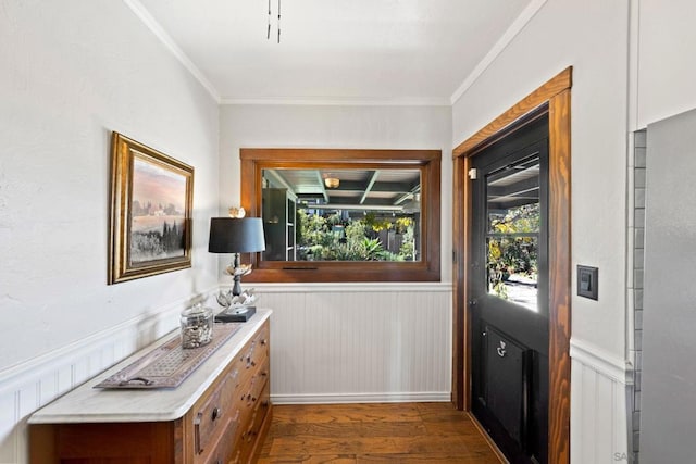 doorway featuring crown molding and dark hardwood / wood-style flooring