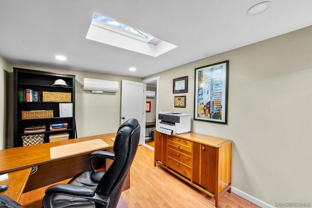 office area with a skylight, light hardwood / wood-style flooring, and an AC wall unit