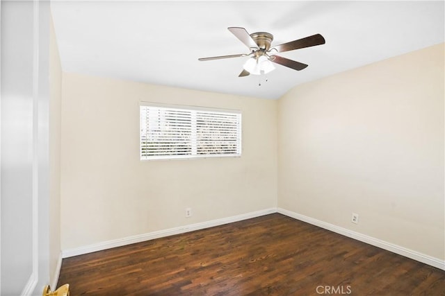 empty room with ceiling fan, lofted ceiling, and dark hardwood / wood-style flooring