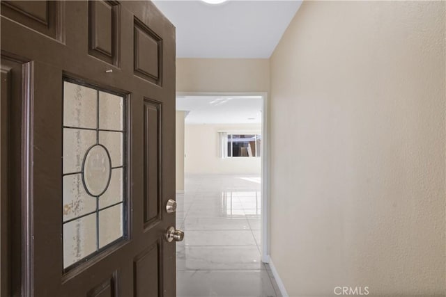 hallway featuring light tile patterned floors