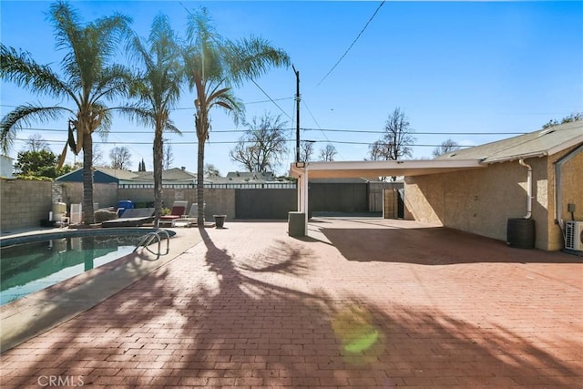 back of property featuring a fenced in pool and a patio area