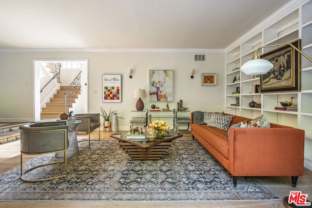 living room featuring ornamental molding and built in features