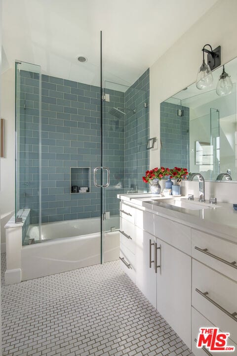 bathroom featuring vanity, combined bath / shower with glass door, and tile patterned floors