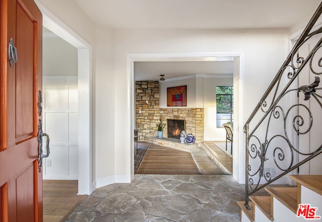 foyer with dark hardwood / wood-style floors and a fireplace